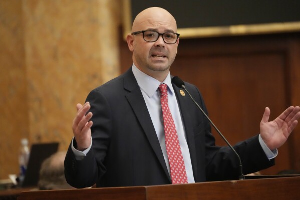 Mississippi House Gaming Committee Chairman Casey Eure, R-Saucier, presents the Mississippi Mobile Sports Wagering Act, legislation that would legalize mobile sports betting while requiring gambling companies to contract with brick-and- mortar gambling establishments, Thursday, Feb. 1, 2024, on the floor of the Mississippi House of Representatives at the state Capitol in Jackson, Miss. (AP Photo/Rogelio V. Solis)