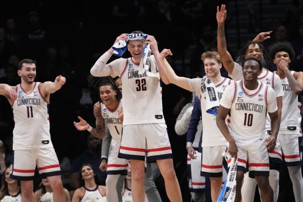 UConn center Donovan Clingan (32) and his teammates reacts in the final seconds of the second half of a second-round college basketball game against Northwestern in the NCAA Tournament, Sunday, March 24, 2024, in New York. UConn won 75-58. (AP Photo/Mary Altaffer)