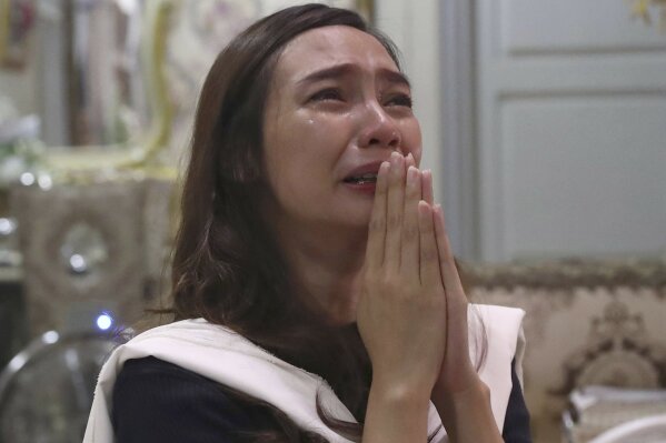 Tri Novia Septiani cries during an online memorial service marking the 40th day since the death of her fiance Dr. Michael Robert Marampe who died of COVID-19, in Jakarta, Indonesia, on June 5, 2020. Marampe knew what he wanted to be since he was a kid: a doctor and a pianist. He became both, and his passion for music even led him to Septiani - a woman he never got to marry because he got the coronavirus. Marampe became one of dozens of doctors the coronavirus has claimed so far in Indonesia. (AP Photo/Tatan Syuflana)