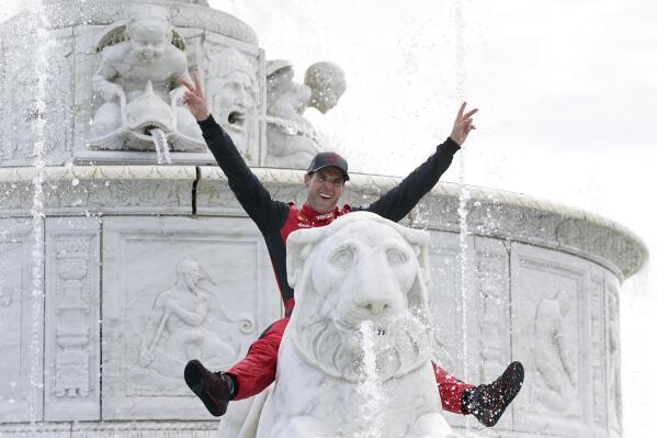Will Power celebrates in the James Scott Memorial Fountain after winning the IndyCar Detroit Grand Prix auto race on Belle Isle in Detroit, Sunday, June 5, 2022. (AP Photo/Paul Sancya)