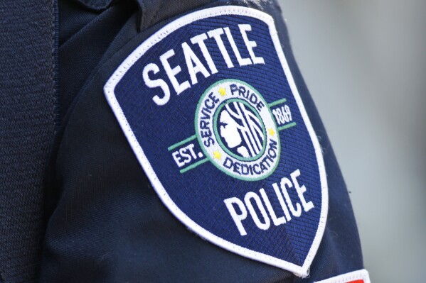  FILE - A Seattle Police Department patch is seen on an officer's uniform, July 17, 2016, in Seattle. The Washington Supreme Court heard arguments Tuesday, June 25,  2024 in a case that will decide whether the names of four Seattle police officers who attended events in the nation’s capital on the day of the insurrection are protected under the state's public records law.  (AP Photo/Ted S. Warren, File)