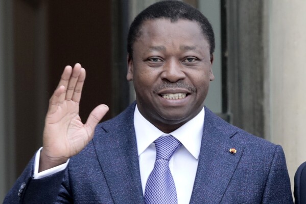 FILE - Togo's President Faure Gnassingbe waves before a working lunch at the Elysee Palace in Paris on April 9, 2021. Activists and opposition leaders in the West African country of Togo called on Wednesday, March 27, 2024, for protests to stop the country's president from signing off on a new constitution that would scrap future presidential elections and could extend his decades-long rule until 2031. (AP Photo/Lewis Joly, File)