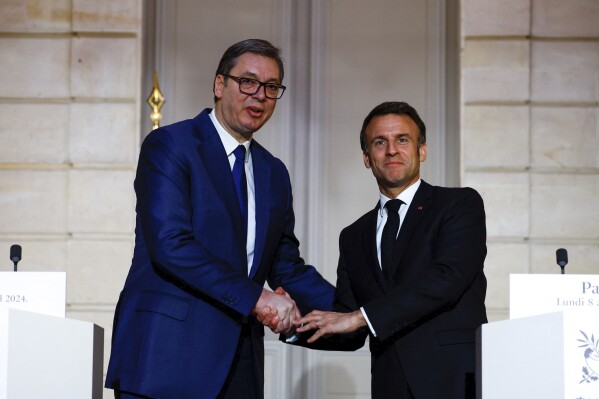 French President Emmanuel Macron, right, and Serbian President Aleksandar Vucic shake hands during a joint statement before a working dinner at the Elysee Palace in Paris, Monday, April 8, 2024. (Sarah Meyssonnier/Pool via AP)