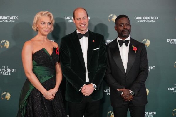 Britain's Prince William, Hannah Waddingham, left, and Sterling K. Brown pose on the green carpet for the 2023 Earthshot Prize Awards in in Singapore, Tuesday, Nov. 7, 2023. (AP Photo/Vincent Thian)