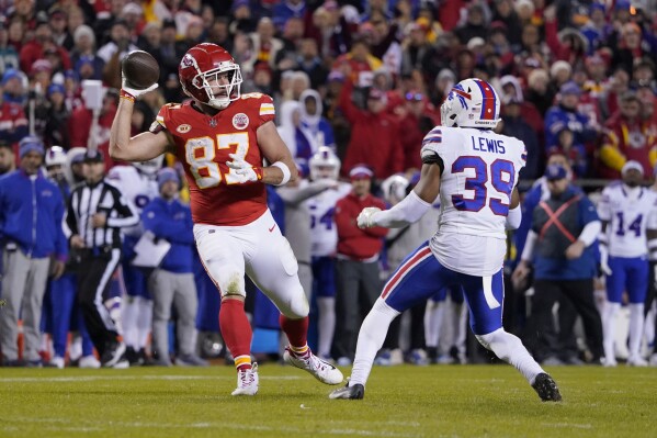 Kansas City Chiefs tight end Travis Kelce (87) laterals to teammate Kadarius Toney, not seen, as Buffalo Bills cornerback Cam Lewis (39) defends during the second half of an NFL football game Sunday, Dec. 10, 2023, in Kansas City, Mo. Toney ran the ball into the end zone, but the play was nullified by an offside penalty by Toney. (AP Photo/Ed Zurga)