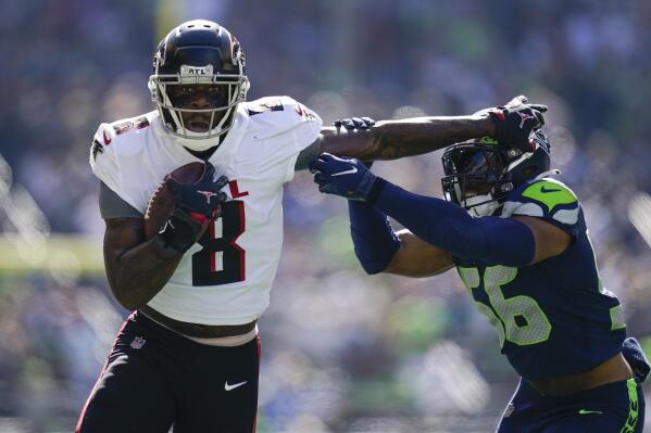 Atlanta Falcons tight end Kyle Pitts gets away from Seattle Seahawks linebacker Jordyn Brooks during the first half of an NFL football game Sunday, Sept. 25, 2022, in Seattle. (AP Photo/Ashley Landis)