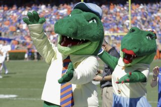 FILE - In this Nov. 7, 2015, file photo, Albert and Alberta, the mascots for Florida, do the gator chomp before the first half of an NCAA college football game against Vanderbilt in Gainesville, Fla. The University of Florida is ending its 'gator bait' cheer at football games and other sports events because of its racial connotations, the school's president announced Thursday, June 18, 2020, in a letter making several other similar changes on campus. (AP Photo/John Raoux, File)