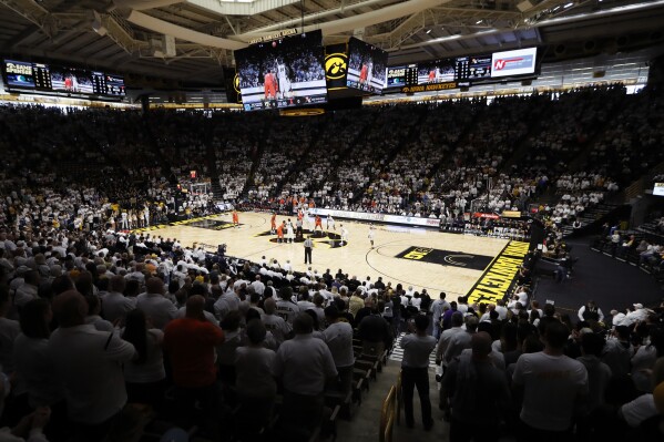 Fans cheer at the start of an NCAA college basketball game between Iowa and Illinois, Feb. 18, 2017, at Carver Hawkeye Arena in Iowa City, Iowa. (AP Photo/Charlie Neibergall, File)