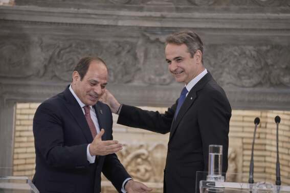 Greece's Prime Minister Kyriakos Mitsotakis, right, and Egyptian President Abdel-Fattah el-Sissi gesture during a joint news conference in Athens, on Wednesday, May 7, 2025. (AP Photo/Petros Giannakouris)