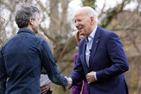 President Joe Biden greets Jack Cunicelli and wife Monica Gagliardi and their daughter Stella, Friday, March 8, 2024, at their home in Rose Valley, Pa. (AP Photo/Manuel Balce Ceneta)