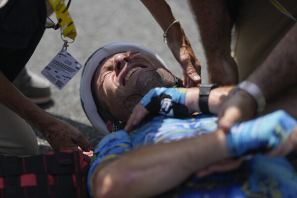 Britain's Mark Cavendish receives medical assistance after crashing during the eighth stage of the Tour de France cycling race over 201 kilometers (125 miles) with start in Libourne and finish in Limoges, France, Saturday, July 8, 2023. (AP Photo/Thibault Camus)