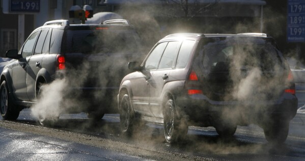 FILE - Cars give off exhaust fumes in Montpelier, Vt., Monday, Jan. 26, 2009. The deaths of three U.S. Marines who suffered carbon monoxide poisoning in a parked car at a North Carolina gas station in July 2023, have stirred speculation about how the situation could have occurred outdoors. (AP Photo/Toby Talbot, File)