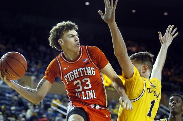Illinois forward Coleman Hawkins (33) passes the ball against Michigan center Hunter Dickinson (1) during the first half of an NCAA college basketball game Sunday, Feb. 27, 2022, in Ann Arbor, Mich. (AP Photo/Duane Burleson)
