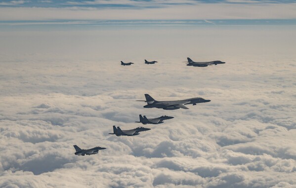 In this photo provided by South Korea Defense Ministry, U.S. Air Force B-1B bombers, F-16 fighter jets, South Korean Air Force F-15K fighter jets and Japanese Air Force F-2 fighter jets fly over South Korea's southern island of Jeju during a joint air drill, Wednesday, Dec. 20, 2023. The United States flew a long-range bomber for joint drills with South Korea and Japan on Wednesday in a show of force against North Korea, days after the North performed its first intercontinental ballistic missile test in five months. (South Korea Defense Ministry via AP)