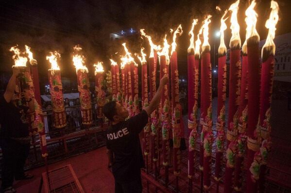 An Indonesian ethnic Chinese man lights joss sticks during the Lunar New Year celebration at a temple in Medan, North Sumatra, Indonesia, early Saturday, Feb. 10, 2024. Chinese around the globe are celebrating Lunar New Year that marks the year of the dragon on the Chinese calendar this year. (APPhoto/Binsar Bakkara)