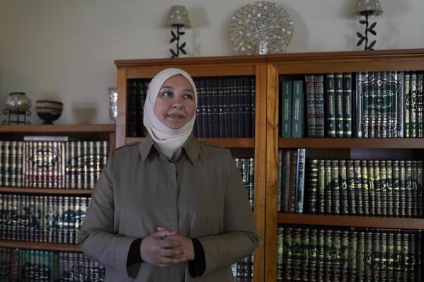 Dr. Rania Awaad stands for a portrait at her home in Union City, Calif., Wednesday, June 23, 2021. Awaad and some other Muslim mental health professionals in the United States, along with some faith leaders and activists, are working to raise awareness about mental illness and suicide prevention and to provide Islamically and culturally sensitive guidance. (AP Photo/Jeff Chiu)