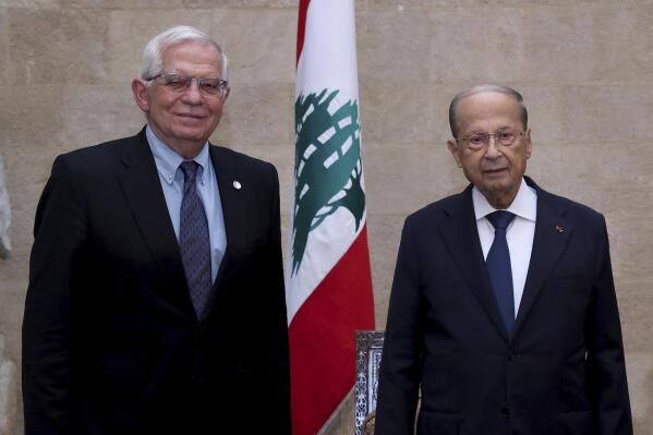 In this photo released by Lebanese government, Lebanese President Michel Aoun, right, meets with European Union foreign policy chief Josep Borrell at the Presidential Palace in Baabda, east of Beirut, Lebanon, Saturday, June. 19, 2021. Borrell berated Lebanese politicians for delays in forming a new Cabinet, warning the union could impose sanctions on those behind the political stalemate in the crisis-hit country. (Dalati Nohra/Lebanese Official Government via AP)