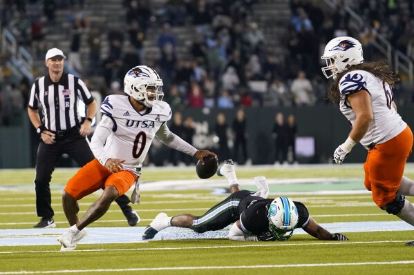 UTSA quarterback Frank Harris (0) scrambles on a fourth down in the second half of an NCAA college football game against Tulane in New Orleans, Friday, Nov. 24, 2023. Tulane won 29-16. (AP Photo/Gerald Herbert)