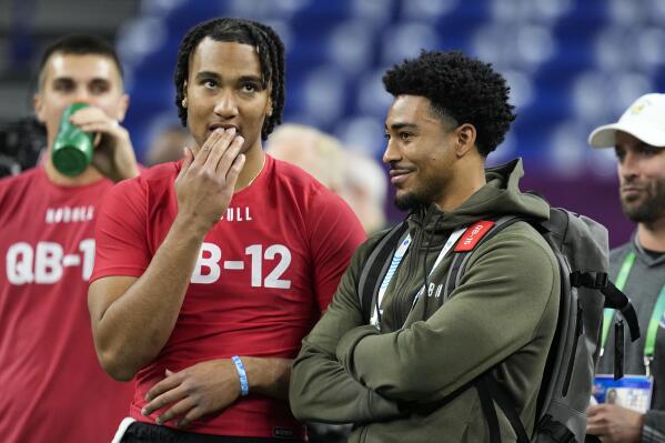 Ohio State quarterback CJ Stroud, left, talks to Alabama quarterback Bryce Young at the NFL football scouting combine in Indianapolis, Saturday, March 4, 2023. (AP Photo/Darron Cummings)