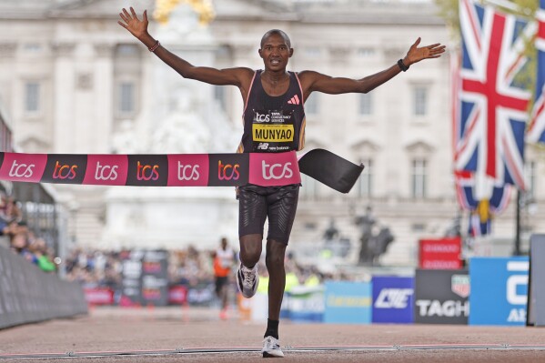 Alexander Mutiso Munyao of Kenya crosses the finish line to win the men's race at the London Marathon in London, Sunday, April 21, 2024.(AP Photo/David Cliff)