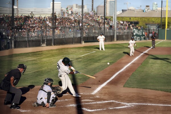 Oakland Ballers' Dondrei Hubbard (20) hits a two-run home run against the Yolo High Wheelers during the first inning of a baseball game at Raimondi Park in Oakland, Calif., Tuesday, June 4, 2024. (Ray Chavez/Bay Area News Group via AP)