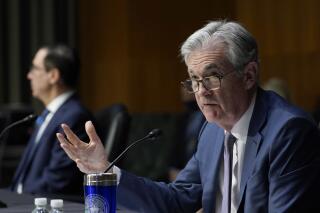 FILE - Federal Reserve Chairman Jerome Powell, right, testifies before the Senate Banking Committee on Capitol Hill in Washington, Tuesday, Dec. 1, 2020. The economy is growing at a healthy clip, and that has accelerated inflation, Federal Reserve Chair Jerome Powell says in written testimony to be delivered Tuesday, June 22, 2021 at a congressional oversight hearing. (AP Photo/Susan Walsh, Pool)