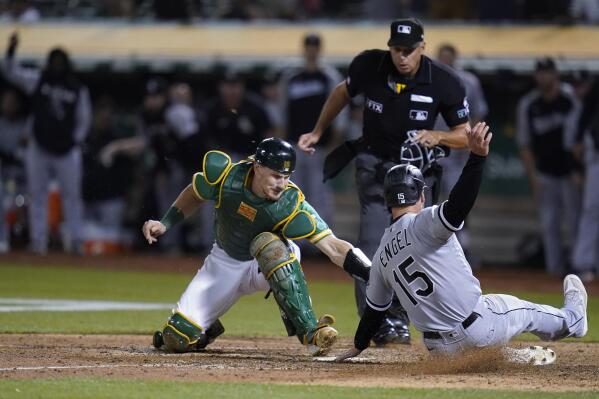 Oakland Athletics catcher Sean Murphy, left, tries to tag Chicago White Sox's Adam Engel (15), who scored the tying run during the ninth inning of a baseball game in Oakland, Calif., Friday, Sept. 9, 2022. (AP Photo/Godofredo A. Vásquez)
