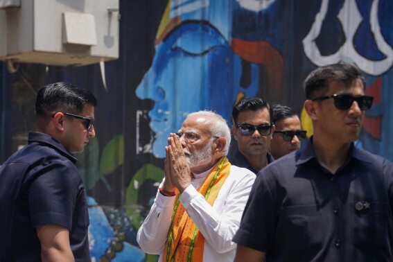 Indian Prime Minister Narendra Modi, flanked by bodyguards, arrives to worship at the Kaal Bhairav temple before filing his nomination papers to contest as a candidate for the parliamentary elections in Varanasi, Uttar Pradesh state, India, Tuesday, May 14, 2024. Varanasi will go to polls on June 1 in the seventh and last phase of the six-week-long election. (AP Photo/ Rajesh Kumar Singh)