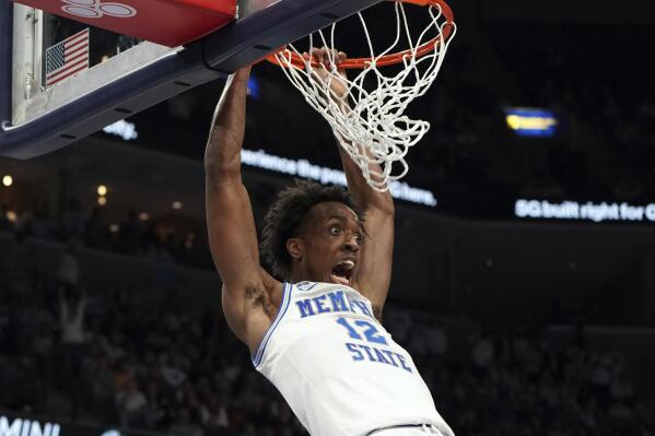 Memphis's DeAndre Williams (12) slam dunks in the second half of an NCAA college basketball game against Alabama Tuesday, Dec. 14, 2021, in Memphis, Tenn. (AP Photo/Karen Pulfer Focht)