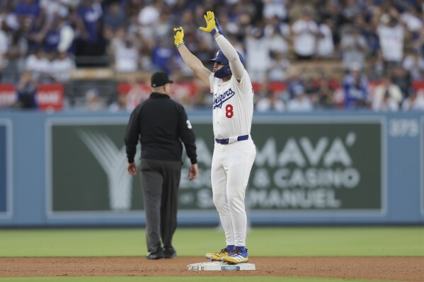Los Angeles Dodgers' Enrique Hernández gestures after hitting a double during the third inning of a baseball game against the Washington Nationals in Los Angeles, Friday, June 20, 2025. (AP Photo/Jessie Alcheh)