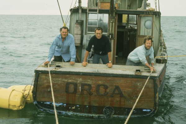 This image released by Peacock shows, from left, Robert Shaw, Roy Scheider and Richard Dreyfuss in a scene from "Jaws." (Peacock/Universal Pictures via AP)