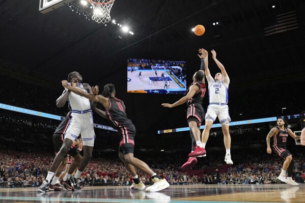 Duke's Cooper Flagg (2) misses a shot as Houston's J'Wan Roberts (13) defends during the second half in the national semifinals at the Final Four of the NCAA college basketball tournament, Saturday, April 5, 2025, in San Antonio. (AP Photo/Eric Gay)