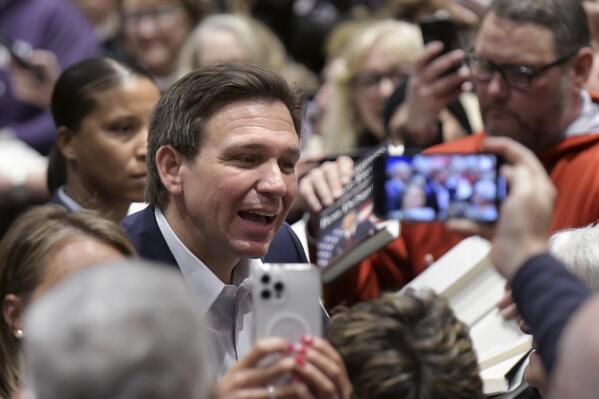 Florida Gov. Ron DeSantis greets people in the crowd during an event Friday, March 10, 2023, in Davenport, Iowa. (AP Photo/Ron Johnson)