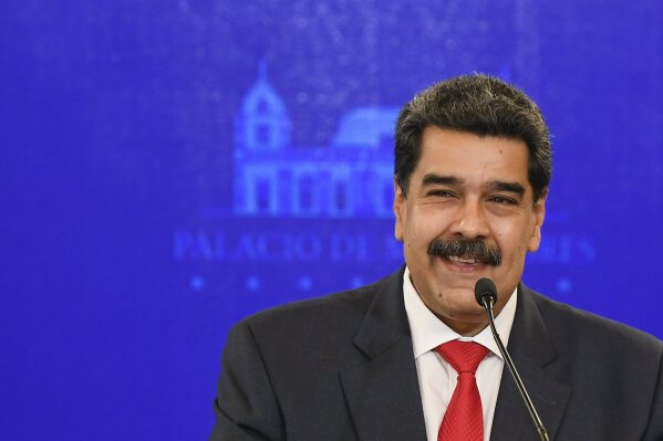 Venezuela's President Nicolas Maduro smiles during a press conference at Miraflores Presidential Palace in Caracas, Venezuela, Tuesday, Dec 8, 2020. Maduro has cemented formal control over all major institutions of power in Venezuela with authorities reporting Monday that his political alliance easily won a majority in congress with 31% of Venezuelans eligible voters voting Sunday. (AP Photo/Matias Delacroix)