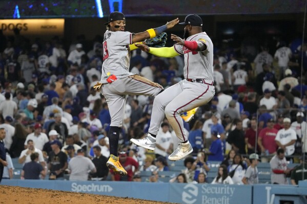 Atlanta Braves' Ronald Acuna Jr., left, celebrates with Marcell Ozuna after the Braves defeated the Los Angeles Dodgers 8-7 in a baseball game Thursday, Aug. 31, 2023, in Los Angeles. (AP Photo/Mark J. Terrill)