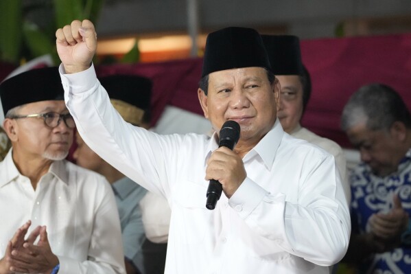 Indonesia's Defense Minister Prabowo Subianto raises his fist as he delivers a speech after being elected as the country's president in Jakarta, Indonesia, Wednesday, March 20, 2024. Subianto was announced the winner of last month's presidential election Wednesday over two former governors who have vowed to contest the result in court over alleged irregularities. (AP Photo/Achmad Ibrahim)