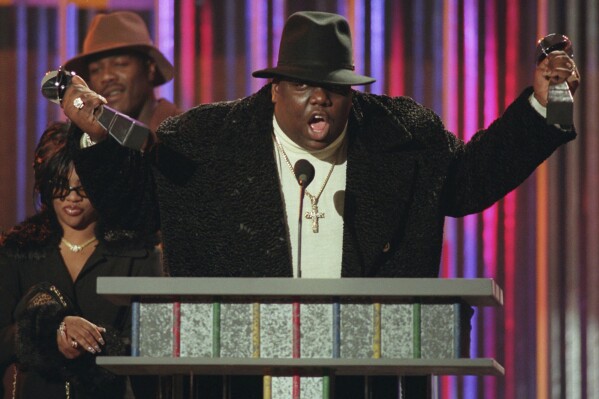 FILE - Notorious B.I.G., who won rap artist and rap single of the year, clutches his awards at the podium during the Billboard Music Awards in New York, on evening, Dec. 6, 1995. Albums from ABBA, Blondie and the Notorious B.I.G. are entering the National Recording Registry at the Library of Congress. They're among the 25 titles announced Tuesday, April 16, 2024, that have been selected for preservation as “defining sounds of the nation’s history and culture." (AP Photo/Mark Lennihan, File)