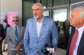 Indiana Gov. Eric Holcomb speaks with reporters following a grand opening ceremony at an Abbott medical device production facility in Westfield, Indiana, on Thursday, July 1, 2021. Holcomb said the state needed "to grind this out" as it works to improve Indiana's lagging COVID-19 vaccination rate. (AP Photo/Tom Davies)