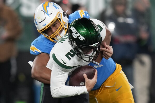 Los Angeles Chargers linebacker Tuli Tuipulotu (45) sacks New York Jets quarterback Zach Wilson (2) during the fourth quarter of an NFL football game, Monday, Nov. 6, 2023, in East Rutherford, N.J. (AP Photo/Seth Wenig)