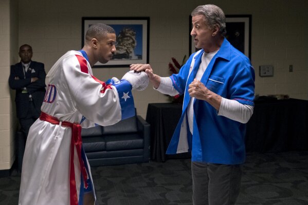 
              FILE - This image released by Metro Goldwyn Mayer Pictures / Warner Bros. Pictures shows Michael B. Jordan, left, and Sylvester Stallone in a scene from "Creed II." The Rocky spinoff “Creed II” has placed second with $35.3 million from the weekend and $55.8 million since Wednesday, far surpassing the first film’s Thanksgiving debut in 2015. (Barry Wetcher/Metro Goldwyn Mayer Pictures/Warner Bros. Pictures via AP, File)
            