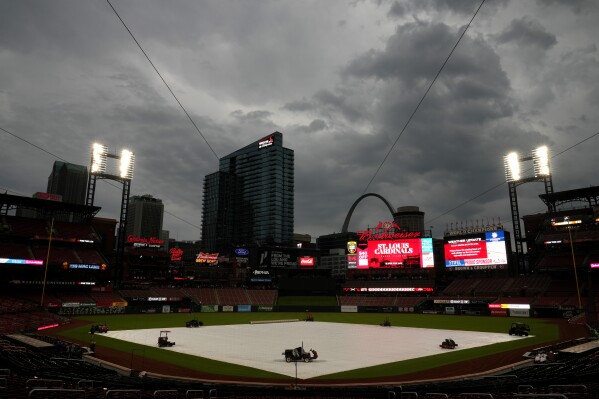 Clouds hang over Busch Stadium as weather delays the start of a baseball game between the St. Louis Cardinals and the New York Mets Wednesday, May 8, 2024, in St. Louis. (AP Photo/Jeff Roberson)