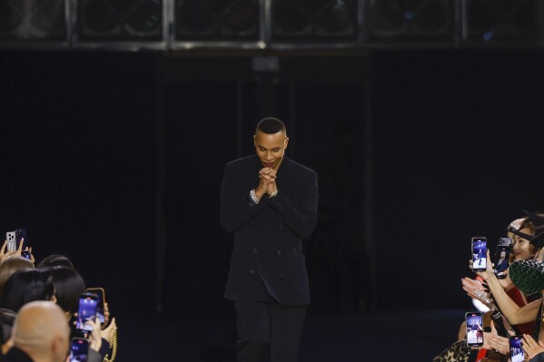 FILE - Designer Olivier Rousteing accepts applause after the conclusion of the Balmain Fall/Winter 2023-2024 ready-to-wear collection presented Wednesday, March 1, 2023 in Paris. Balmain artistic director Olivier Rousteing says robbers have made off with more than 50 pieces of the new collection that his Paris house intends to show at Fashion Week later this month. (Vianney Le Caer/Invision/AP, file)