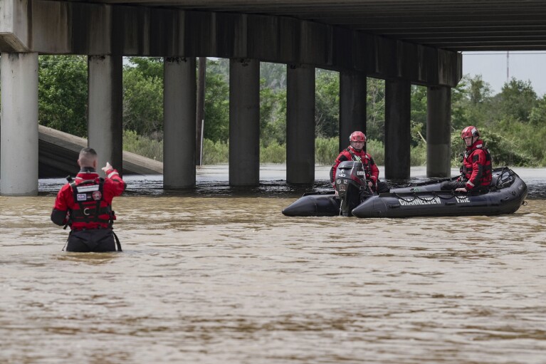 The Channelview Fire Department and sheriffs prepare to help evacuate the area due to severe flooding, Saturday, May 4, 2024, in Channelview, Texas.  (Raquel Natalicchio/Houston Chronicle via AP)