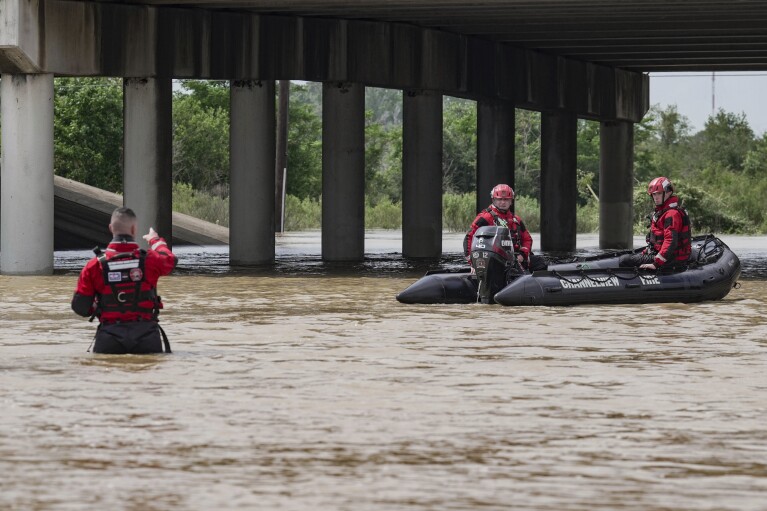 Channelview Fire Department and Sheriff's Office prepare to evacuate the area due to severe flooding, Saturday, May 4, 2024, in Channelview, Texas.  (Raquel Natalichio/Houston Chronicle, via AP)