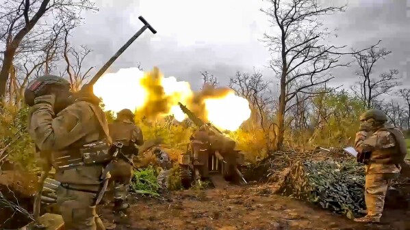 FILE - In this image taken from video released by the Russian Defense Ministry Press Service on Aug. 8, 2023, a Russian howitzer fires toward Ukrainian positions at an undisclosed location. Russian President Vladimir Putin has cast the conflict in Ukraine as a life-or-death battle against the West, with Moscow ready to protect its gains at any cost. (Russian Defense Ministry Press Service via AP, File)
