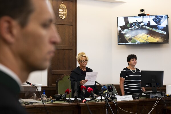 Judge Dr. Leona Németh delivers a verdict on the court of the captain of a river cruise boat in Budapest, Hungary, Tuesday, Sept. 26, 2023. Yuriy Chaplinsky, the captain of a river cruise boat that collided with another vessel in Hungary's capital in 2019, killing at least 27 mostly South Korean tourists has been found guilty of negligence and sentenced to five years and six months in prison. (AP Photo/Denes Erdos)