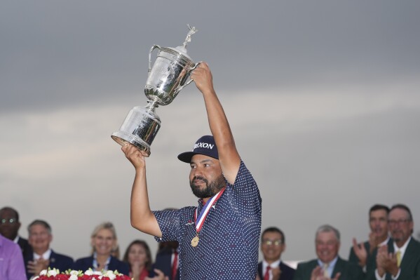 J.J. Spaun celebrates with the trophy after winning the U.S. Open golf tournament at Oakmont Country Club Sunday, June 15, 2025, in Oakmont, Pa. (AP Photo/Seth Wenig)