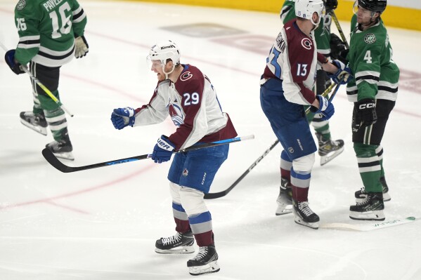 Colorado Avalanche center Nathan MacKinnon (29) celebrates in front of right wing Valeri Nichushkin (13) and Dallas Stars defenseman Miro Heiskanen (4) after scoring a goal in the third period in Game 2 of an NHL hockey Stanley Cup second-round playoff series in Dallas, Tuesday, May 7, 2024. (AP Photo/LM Otero)