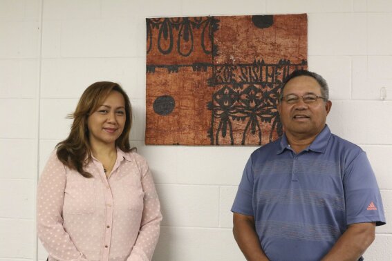 In this Jan. 10, 2020, Bonnelley Pa'uulu, left, and Filipo Ilaoa pose for a photo at the American Samoa government office in Honolulu. Some American Samoans worry a federal judge's recent ruling in Utah saying those born in the U.S. territory should be recognized as U.S. citizens could threaten "fa'a Samoa," or the Samoan way of life. (AP Photo/Jennifer Sinco Kelleher)