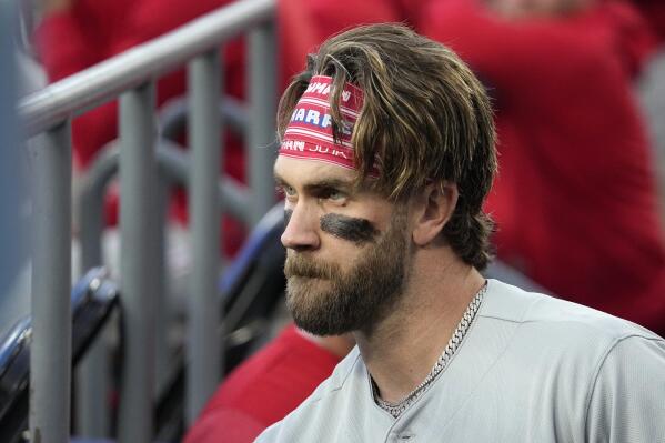Philadelphia Phillies' Bryce Harper stands in the dugout prior to a baseball game against the Los Angeles Dodgers Tuesday, May 2, 2023, in Los Angeles. (AP Photo/Mark J. Terrill)